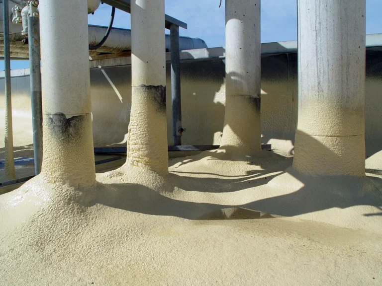 Spray foam applied around rooftop pipe penetrations
